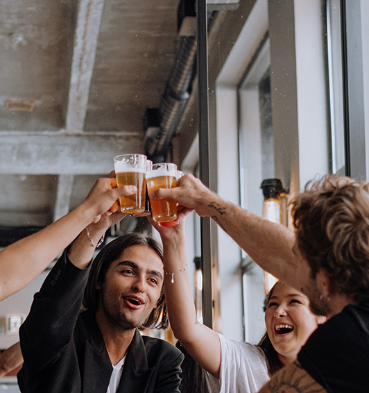 Friends making a toast with beer glasses.