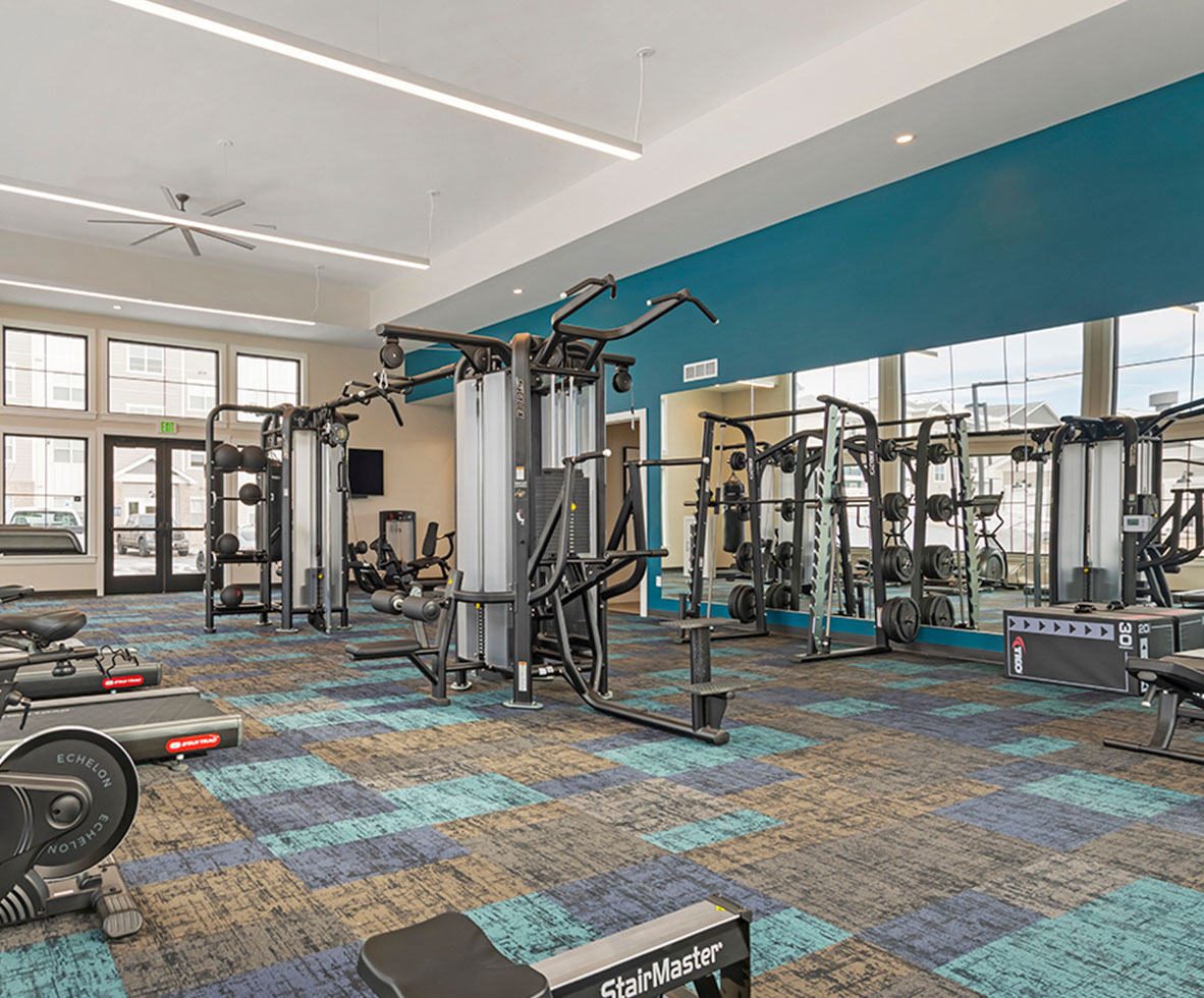 Fitness center with weight machines and cardio machines.